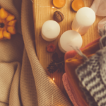 image of fall decor including mini pumpkins candles and warm fuzzy blankets