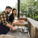 image of a couple cooking in their outdoor kitchen