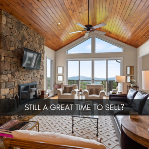 image of a cozy living room with a stone fireplace and a view of the mountains